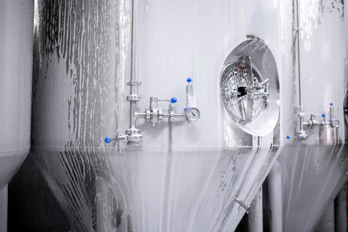 Foam washing stainless steel processing equipment in a factory